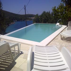Swimming pool with massage jets and counter