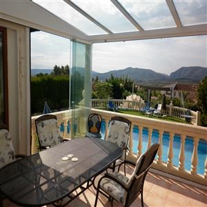 Covered terrace for meals with glass curtains