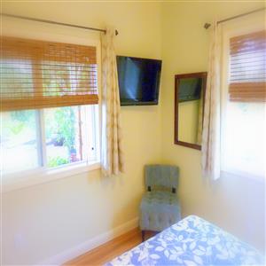 Bedroom has extra 32" wall-mounted flat screen TV