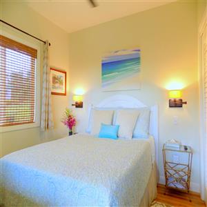 Queeen size bed in private bedroom within suite