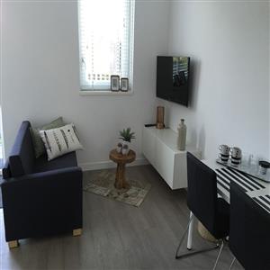 Sit area with couch, table with four chairs, TV...