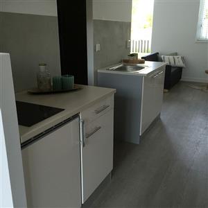 Fully equipped kitchen with sink, ceramic plates