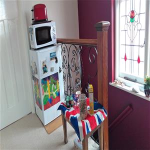 Upstairs landing with fridge, microwave, and toast